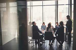 Directors and officers in the middle of a board meeting about insurance