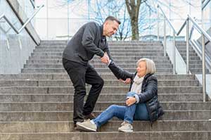 Woman who fell down stairs in front of a business