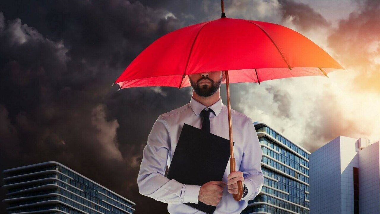 businessman with umbrella in city center