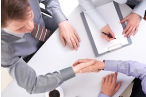 business people shaking hands after contract sign for trade association insurance