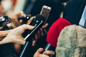 multiple reporters holding mic's