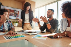 creative start-up team discussing ideas in board room