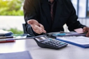 man showing the total cost on calculator