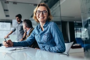 female office worker sitting in board room