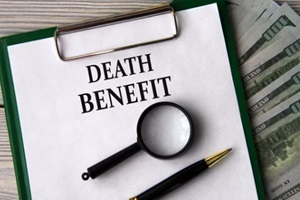 DEATH BENEFIT - words on a white sheet on the background of banknotes