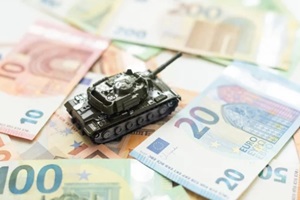 toy tank on US hundred dollar bills banknotes close up