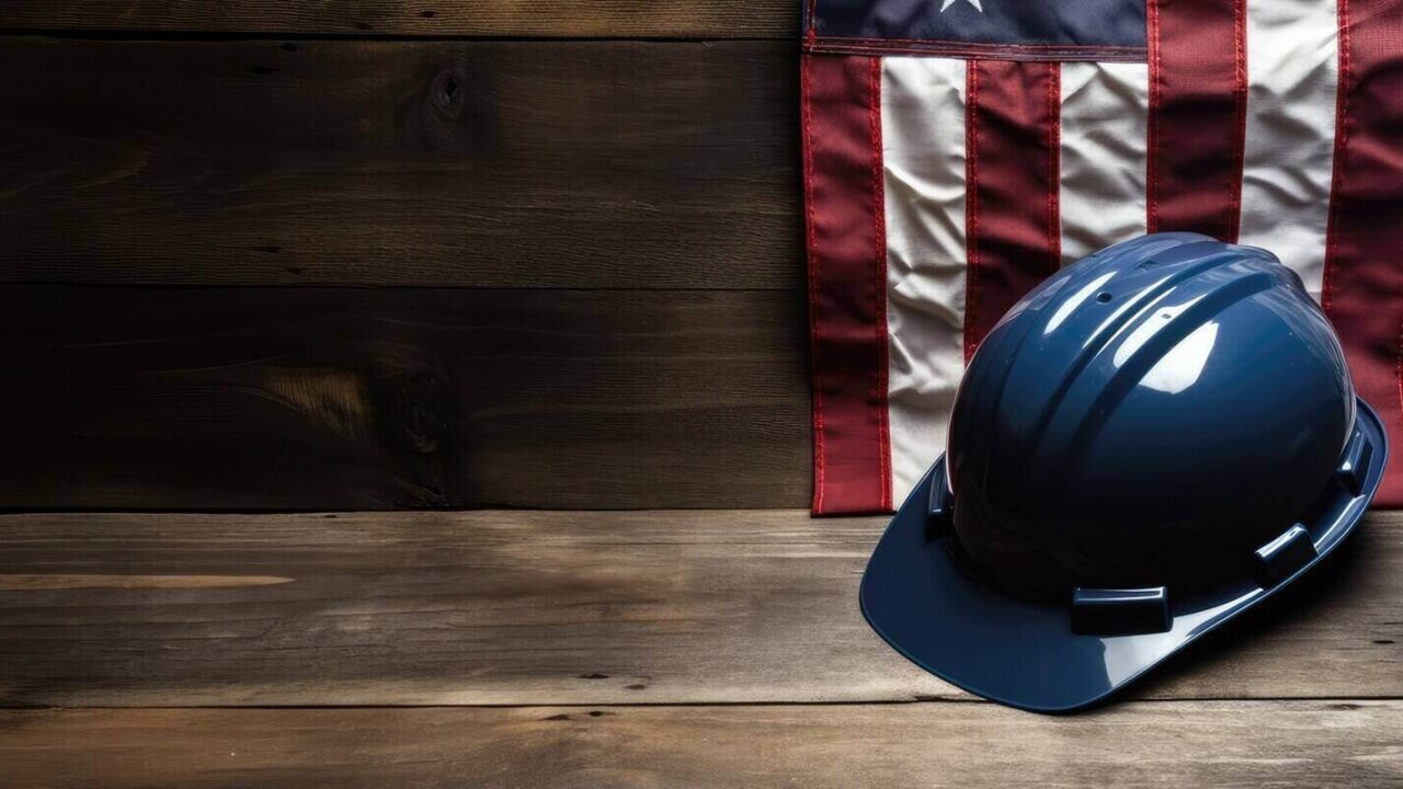 american flag with different construction tools on dark wooden background