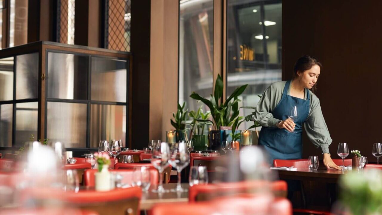 female waitress setting tables