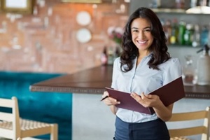 smiling mixed race waitress holding a file