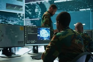 programming engineer soldier handles AI brain and deep learning data on computer in command post