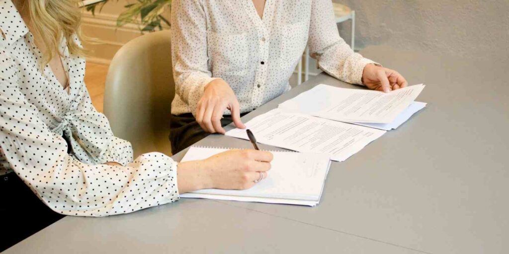 Professional Woman Signing Insurance Paper
