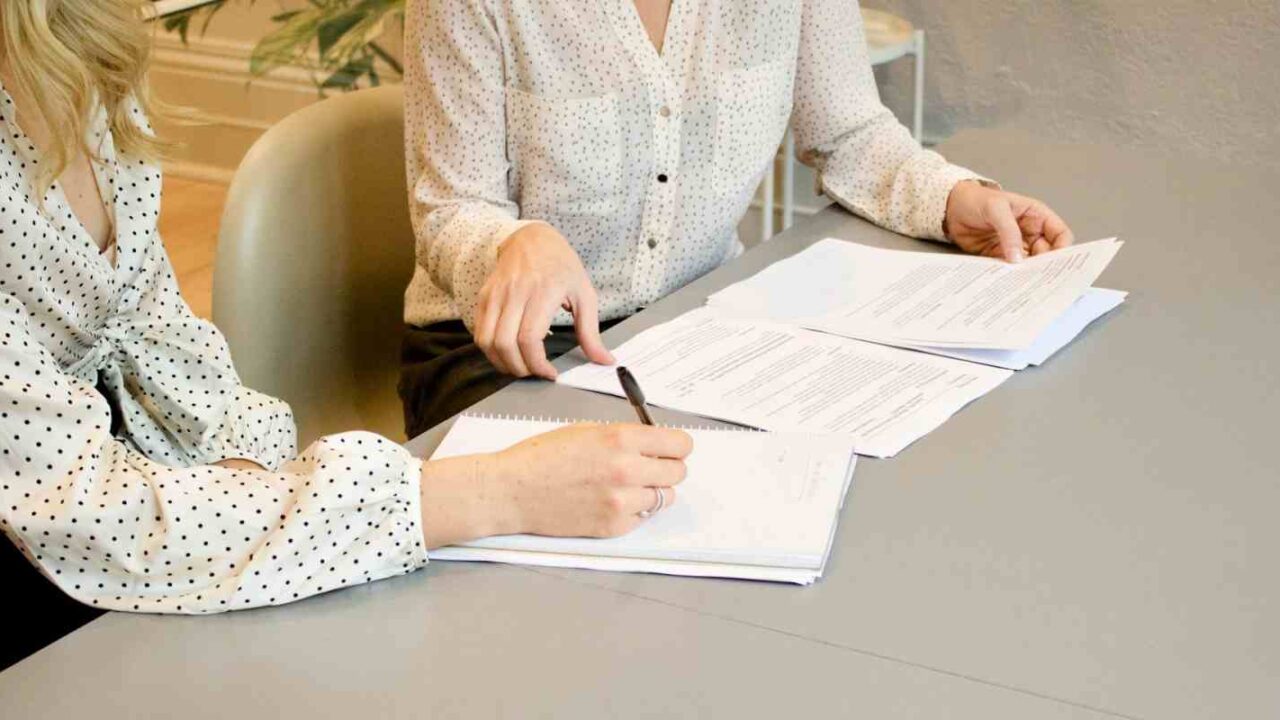 Professional Woman Signing Insurance Paper