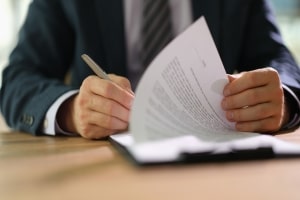 Businessman Signing Insurance Documents