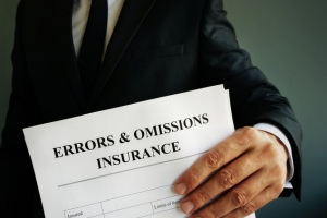 Businessman Holding E & O Insurance Documents in Hand