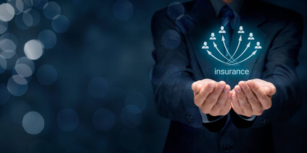 Businessman Putting Hand Below Digital Interface with Insurance Text and Employee Icons