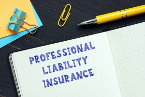 Professional Liability Insurance Text Written on a Notebook