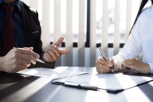 Business People Assessing E&O Insurance Needs in Office