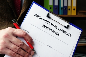 Engineering Firm Executive Holding Professional Liability Insurance Form on Clipboard