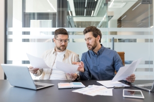 Engineering Firm Partners Comparing General Liability and Professional Liability Insurance Policies