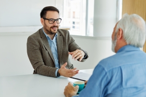 Businessman Communicating with Client in His Office